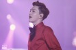 Suho in red shirt and black bow tie