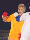 Tao in a very bright yellow shirt with red gloves